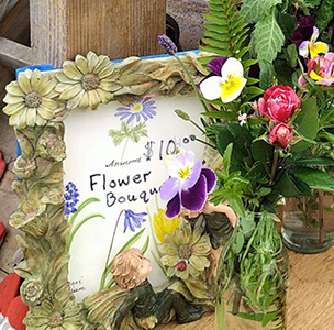 Fresh herbs and flowers in a little posy wrapped in ribbon.